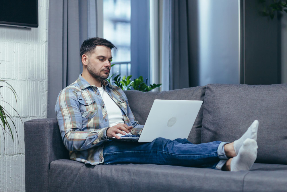 Man using latop sitting in sofa