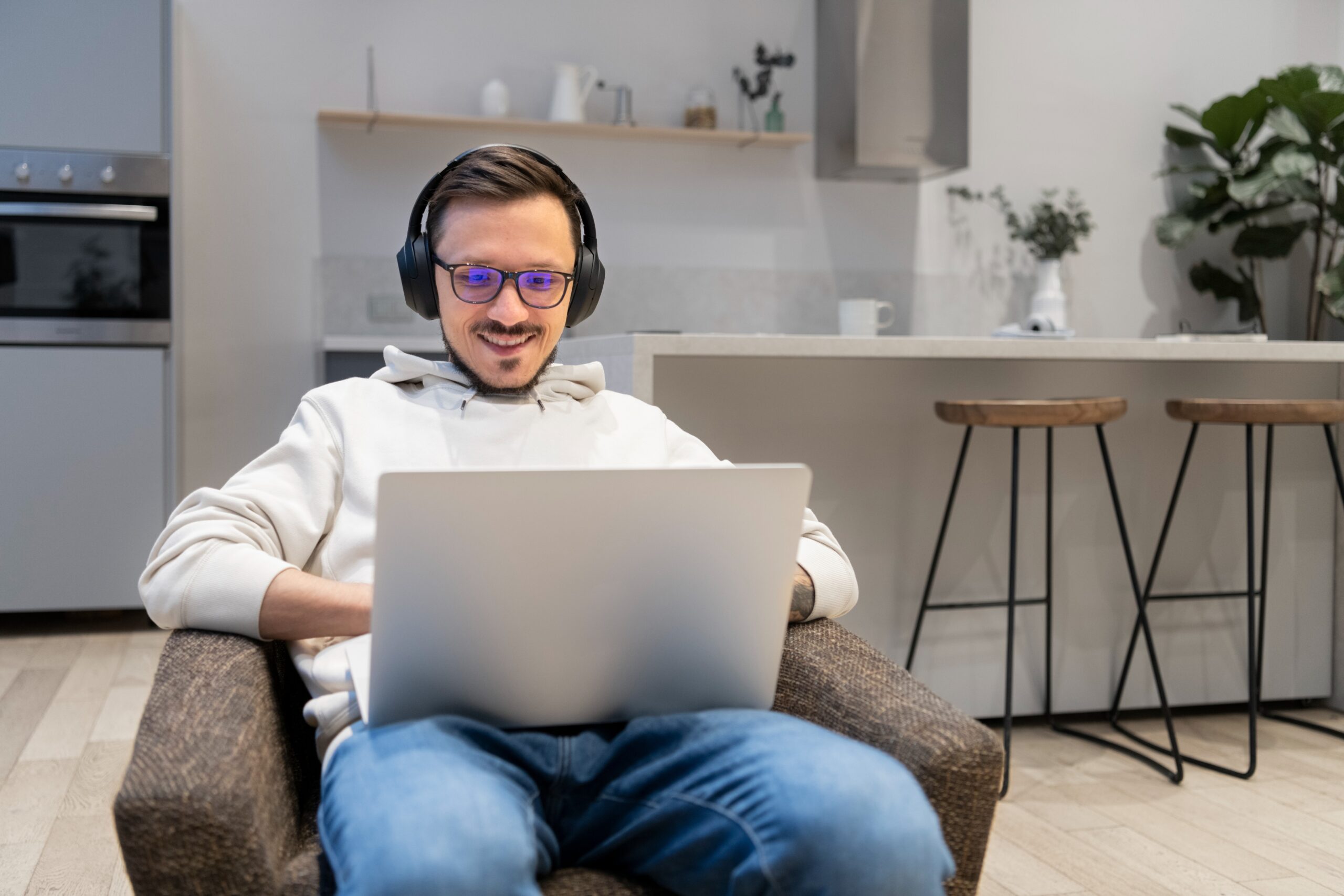 man-working-from-home-kitchen-with-laptop